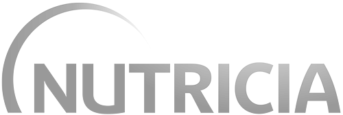 A person is mid-air, skateboarding down a set of stairs with a handrail, while others watch—a bold move that mirrors the energy and calculated risks of an innovative product launch in healthcare marketing. The sun shines on this vibrant outdoor scene.