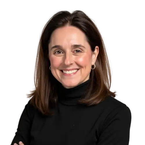 A woman with shoulder-length brown hair, wearing a black turtleneck and silver hoop earrings, smiles with arms crossed against a plain background—reflecting the confidence and creativity at a leading healthcare marketing agency.