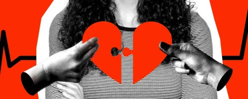 A person holding a red broken heart puzzle piece, with two hands reaching toward it, set against a red background with black heartbeat lines—symbolizing the impact of cardiovascular disease in women.